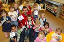 Saints player Paul Wotton visting Woodlands Nursery and Pre-School to hand out free milk to the children.
