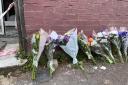 Flowers are left at the scene in Napier Road, East Ham, London (Rosie Shead/PA)