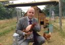 Head teacher Jason Ashley with one of the chickens in Lucy's Garden.