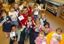 Saints player Paul Wotton visting Woodlands Nursery and Pre-School to hand out free milk to the children.