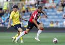 Oxford United’s Mark Harris and Southampton’s Charlie Taylor battle for the ball during the pre-season friendly match at the Kassam Stadium, Oxford.