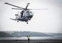 Undated handout photo issued by the Ministry of Defence of a Merlin helicopter conducting training with HMS Queen Elizabeth while anchored just off Plymouth Sound. This image won the Royal Navy Amateur Maritime Image Award, taken by AB Bill Spurr, in the