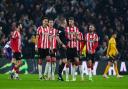 Southampton players surround referee Thomas Bramall after conceding a second goal at Wolves