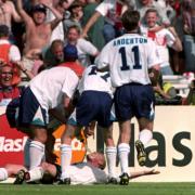 Paul Gascoigne is swamped by England teammates after scoring their second goal in the Euro 96 clash against Scotland, at Wembley..