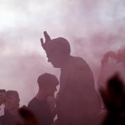 Southampton fans on top of the statue of former manager Ted Bates outside the stadium