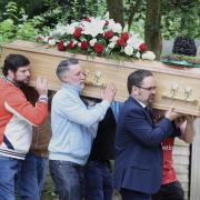 Elijah Khaira's coffin is carried into St Peter's Church by friends