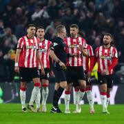 Southampton players surround referee Thomas Bramall after conceding a second goal at Wolves