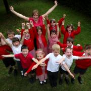 WELL DONE: Foxhills Infant School head Jane Barrett pictured with her pupils celebrating the school’s Ofsted report. 	Echo picture by Stuart Martin. Order no: 8858000