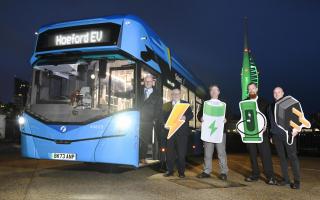 The First Bus Solent team with Spinnaker Tower in Portsmouth lit up green to mark the arrival of the buses