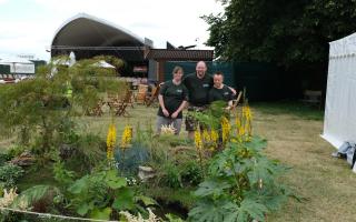 Rhianne, Liam and Simon standing behind their garden