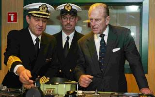ON THE BRIDGE: The Duke of Edinburgh with Captain Paul Wright and chief engineer Brian Whattling, during his tour of the QM2 ten years ago.