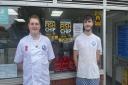 Mike Isaac, 31, and Jacob Grigg, 22, standing in front of Mike's Traditional Fish and Chips in Eastleigh.