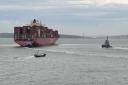 Container ship One Maneuver being assisted by three tug boats and the harbour master.