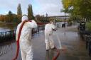 Worcester City Council workers cleaning pathways after River Severn flooding.