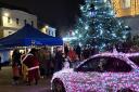 Singers gather round the Christmas tree for a carol concert