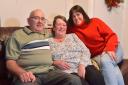 Foster carers and parents Kath and John Campbell, pictured alongside their daughter Joanne