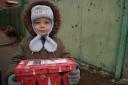 A child in Partyzans'ke, a village east of Mykolaiv, receives a Blythswood shoebox