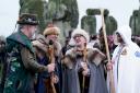 People take part in the winter solstice celebrations during sunrise at the Stonehenge prehistoric monument on Salisbury Plain in Wiltshire.