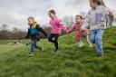 Children playing in the parkland at Easter at Gibside, Tyne & Wear