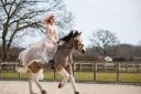 A bride riding her horse at her Langford Farm wedding