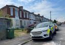 Police cordoned off the house after three people were stabbed on Friday