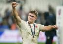 Theo Dan celebrates England's bronze medal at the Rugby World Cup. Image: PA