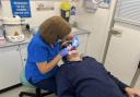 Dentist Mary Green treats a patient on the mobile dental unit