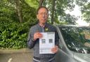 Jon Windeatt, 87, holding a previous Parking Charge Notice (PCN).