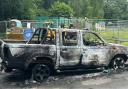 The burnt-out van has been left at the playing field in Hythe