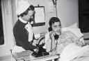 Patient Richard Parrish makes the historic call with the assistance of ward sister B Jagger,