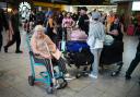 Elaine Bevan, 70, from Southampton, waits in the South Terminal at Gatwick Airport in Crawley, east Sussex, as widespread IT outages affecting airlines, broadcasters and banks, have caused long queues.