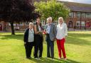 Paige Allen, centre left, and her adoptive mother Julie Allen, being presented with her bursary award by John and Marion Greenwood