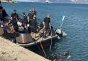 Divers in the 17 Port and Maritime Regiment plunge into the water during training