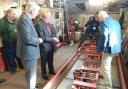 The Duke of Gloucester views parts of the railway carriage in which his uncle, King George VI, travelled along Hythe Pier in 1944