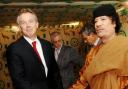 Dressing as terrorists is deemed inappropriate, such as Colonel Muammar Gaddafi, pictured right at a meeting with Tony Blair.