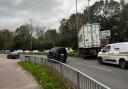 Delays as lorry crashes at roundabout - live updates