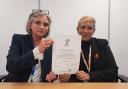 The signed covenant being held by Maggie MacIsaac, Chief Executive, and Lena Samuels, Chair, NHS Hampshire and Isle of Wight