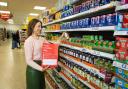 A Tesco colleague with a food donation bag