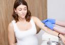 A pregnant woman receiving a vacination