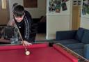 A student at The Polygon School playing pool