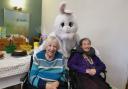 Court Lodge residents Irene Fraser and Sybil Skinner meet the Easter Bunny. 