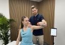 Tom Jenkins assessing a patient at Vida Physio in Romsey