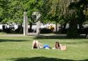 People enjoying the warm weather in Palmerston Park