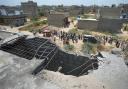 A big hole is seen on the roof of a house suspected to have been damaged in an Indian drone attack in Karachi, Pakistan (Fareed Khan/AP)