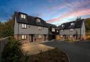 Sleek townhouse exterior showcases eco-conscious design and modern architecture
