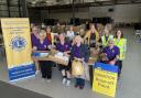 Boxes of hygiene items and food stacked for Ukraine-bound transport
