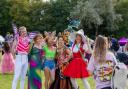 Children gather around a fairy puppet show at the New Forest festival.Colorful wings and handmade wands fill the woodland during the weekend event
