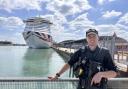 PS Max Preston stood next to Ocean Cruise Terminal as police explained why armed patrols are increasing.