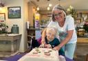 Stella cuts the cake with daughter Janice