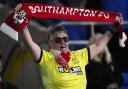 A Southampton supporter celebrates in the stands during an away fixture